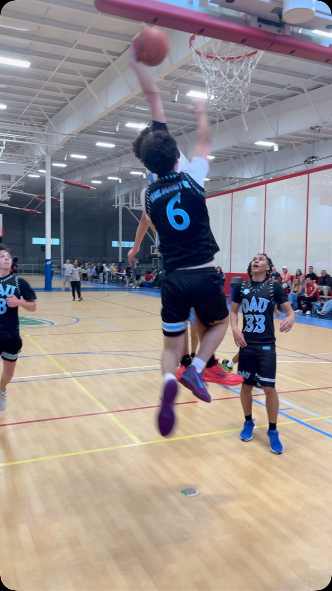 We All Hoop AAU player rising for a finish at the rim during a game